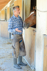 a man is at stable door