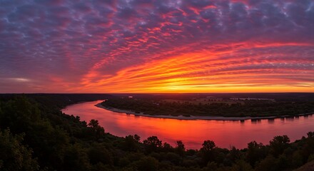 Fototapeta premium Spectacular river landscape with vibrant sunrise colors painting the sky and water creating a