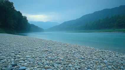 Muted river valley; pebbles on shore, misty, moody scene