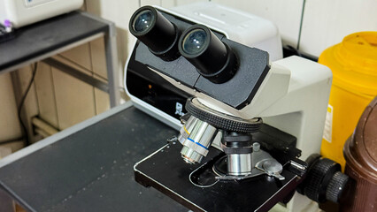 Intricate microscope dances on laboratory table, evoking World Microscope Day and hidden germ...