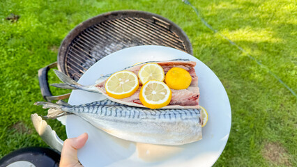 Grilled mackerel with lemon slices evokes al fresco feasts and seafood folklore, perfect for...