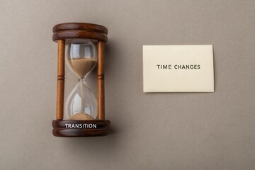 Wooden hourglass with sand representing time transition concept