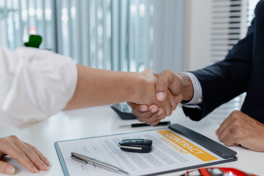 A professional car sales process showing contract signing, financial discussion, key handover, and handshake between client and dealer, symbolizing trust, agreement, and successful deal.