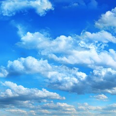 Obraz premium A vivid display of clouds against a vibrant blue sky, creating a sense of calmness and freedom. The fluffy clouds add depth and texture to the bright, sunny atmosphere.