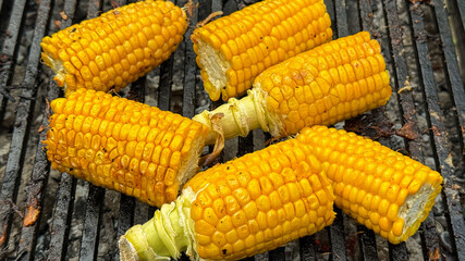 Golden cobs sizzle on the grill, evoking summer solstice feasts, rustic picnics, and harvest moon gatherings, vibrant celebration April 5 2025, Barcelona, Spain