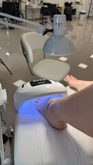 A pale-skinned female foot bathes in ethereal blue light, evoking tranquility during the ancient...