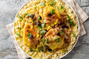 Moroccan Couscous Tfaya Sweet and Savoury Couscous with braised Chicken closeup on the plate on the table. Horizontal top view from above