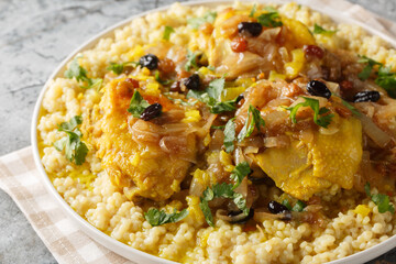 Moroccan Couscous Tfaya Sweet and Savoury Couscous with braised Chicken closeup on the plate on the table. Horizontal