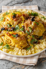 Moroccan Tfaya Couscous With Braised Chicken closeup on the plate on the table. Vertical