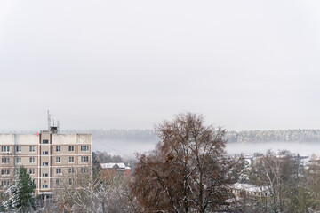 White fog spreads across the valley and covers the village