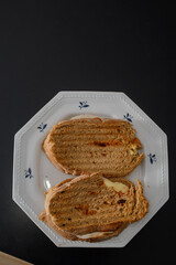 Sandwiches made of homemade bread toasted with ham, spreadable cheese and ketchup inside. Homemade food that is always good to start or end the day.