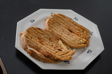 Sandwiches made of homemade bread toasted with ham, spreadable cheese and ketchup inside. Homemade food that is always good to start or end the day.