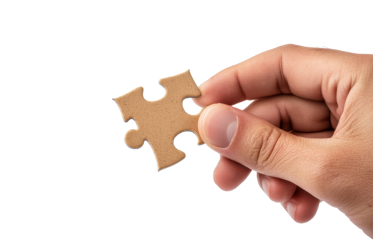 Hand holding a single brown puzzle piece isolated on transparent background. Hand holding single piece of puzzle isolated on white background.