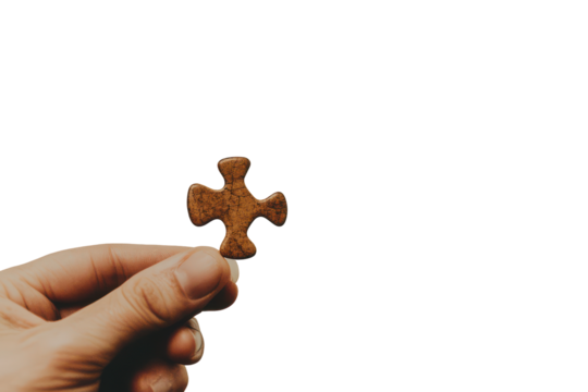 Hand holding a single brown puzzle piece isolated on transparent background. Hand holding single piece of puzzle isolated on white background. - Powered by Adobe
