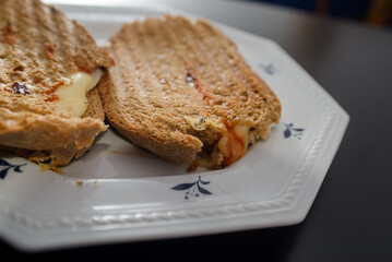 Sandwiches made of homemade bread toasted with ham, spreadable cheese and ketchup inside. Homemade food that is always good to start or end the day.