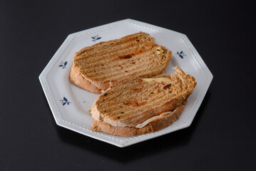 Sandwiches made of homemade bread toasted with ham, spreadable cheese and ketchup inside. Homemade food that is always good to start or end the day.