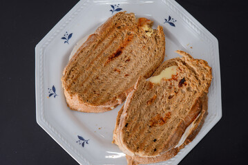 Sandwiches made of homemade bread toasted with ham, spreadable cheese and ketchup inside. Homemade food that is always good to start or end the day.