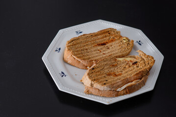 Sandwiches made of homemade bread toasted with ham, spreadable cheese and ketchup inside. Homemade food that is always good to start or end the day.
