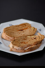 Sandwiches made of homemade bread toasted with ham, spreadable cheese and ketchup inside. Homemade food that is always good to start or end the day.