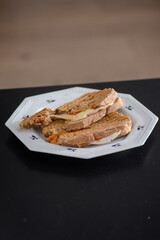 Sandwiches made of homemade bread toasted with ham, spreadable cheese and ketchup inside. Homemade food that is always good to start or end the day.
