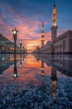Mosque reflected in a puddle at dawn