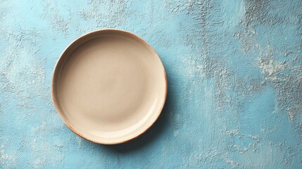 Empty light beige plate, slightly textured, centered on a blue textured background