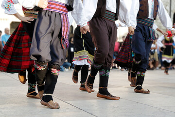Dancers dancing and wearing one of the traditional folk costume from Uzide, Serbia