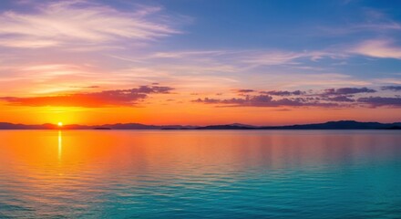 Obraz premium Vibrant sunset over a calm ocean with colorful sky and reflections on the water