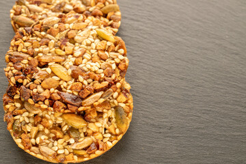 Thaler cookies with nuts and honey, on a slate stone, close-up.