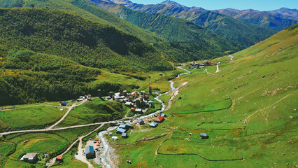 Aerial view of an alpine village in the middle of a sunny summer day.