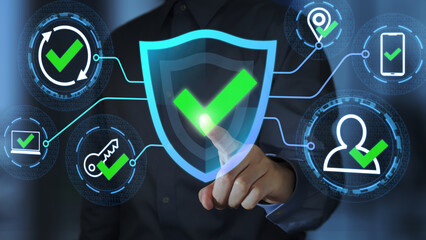 Multi-Factor Authentication MFA. Passwordless and continuous authentication. Businessperson tapping a shield icon with a checkmark.