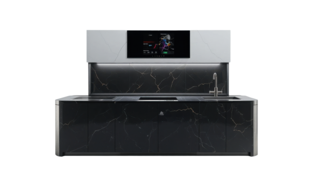 A high-tech kitchen counter setup with subtle under-cabinet lighting and an integrated smart display panel, made from a glossy black solid surface material. It sits on a stark white background.