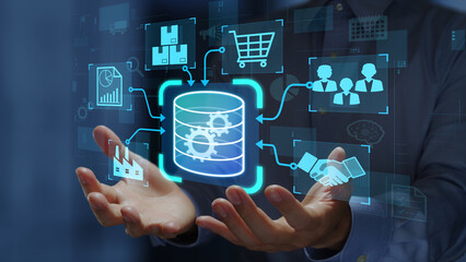 Enterprise resource planning ERP system. Real-time project management and data integration. Businessperson holding database icon. © tadamichi