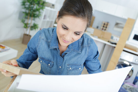 a female worker is assembling furniture