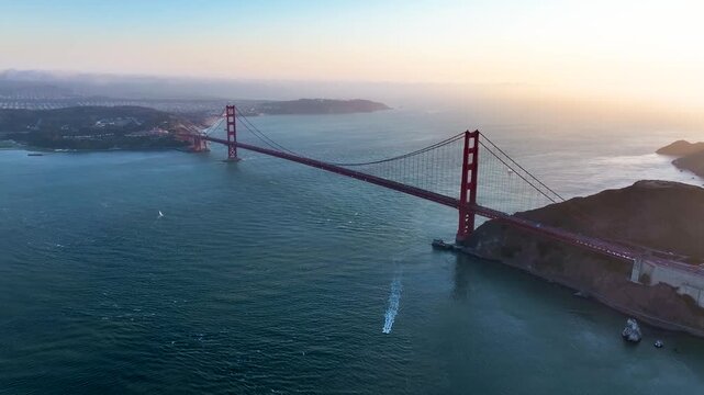 Aerial view of the Golden Gate Bridge spanning the shimmering waters, a testament to human engineering against nature's backdrop, San Francisco, California, United States.
