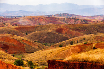 Dramatic landscape of heavily eroded red laterite hills and valleys in the Befato area of the central highlands of Madagascar
