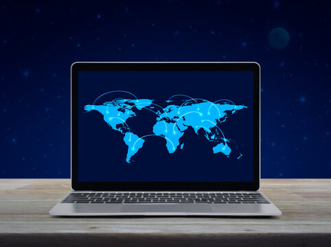 Connection line with global world map on laptop computer monitor screen on wooden table over fantasy night sky and moon, Business communication online concept, Elements of this image furnished by NASA