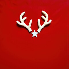 a red background with white deer antlers and a star