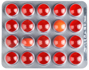 Overhead view of blister pack containing red and one orange colored pills