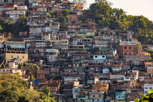 Dense housing on a steep hillside in a favela community of Santa Teresa in Rio de Janeiro, Brazil, showcasing colorful, tightly packed homes.