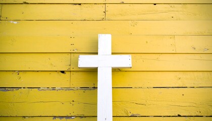 White cross on yellow wooden wall