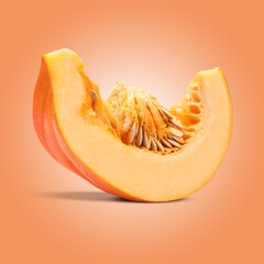 Slice of ripe pumpkin on coral color background