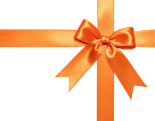 Close-up of a cross of orange ribbon, tied in a bow against a black background
