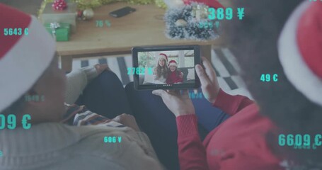Mother and daughter tapping tablet on tech app initiating family call animating currency symbols - Powered by Adobe
