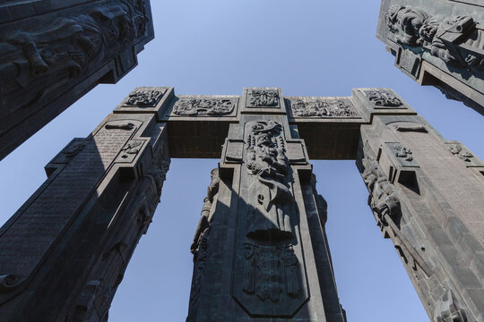 View of the towering Chronicles of Georgia monument, adorned with intricate carvings under a clear sky, standing as a testament to history, Tbilisi, Tbilisi, Georgia.