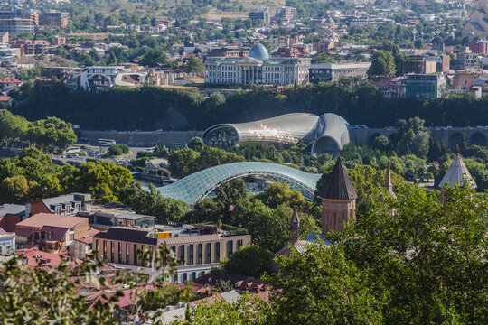 View of modern architectural marvels interplaying with classical structures amidst lush greenery in the vibrant cityscape, Tbilisi, Tbilisi, Georgia.