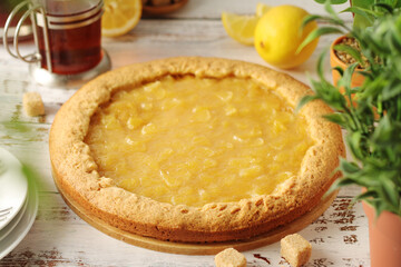 A tart with lemon marmalade served on the table