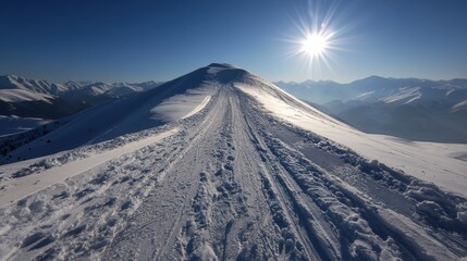 Crisp Winter Sunlight Illuminating Snowy Mountain Peak with Tire Tracks and Distant Mountain Range