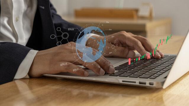 Businessman typing on laptop with digital global stock chart overlay, showing economic data analysis, global finance trends, and market performance in modern office setting