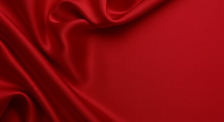 Elegant red fabric drapes with soft folds and flowing texture